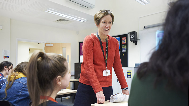 EPQ- Member of staff interacting with students in a class