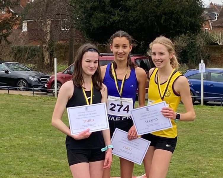 Pippa (in the middle), Senior Girls Surrey Schools 4 km Cross-County competition winner 2022