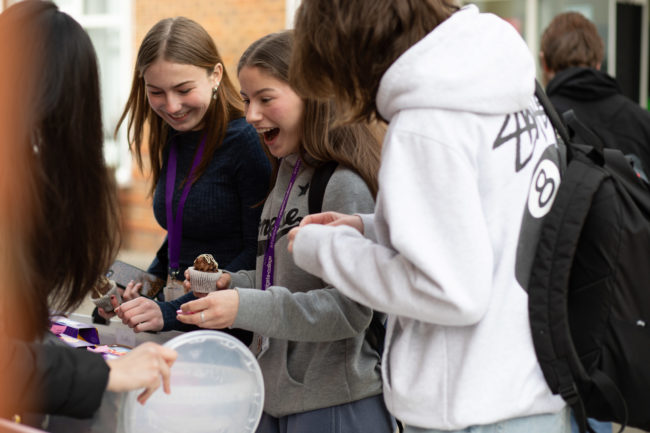 Charity Week 2022 - Students purchasing some cakes from the cake sale stall
