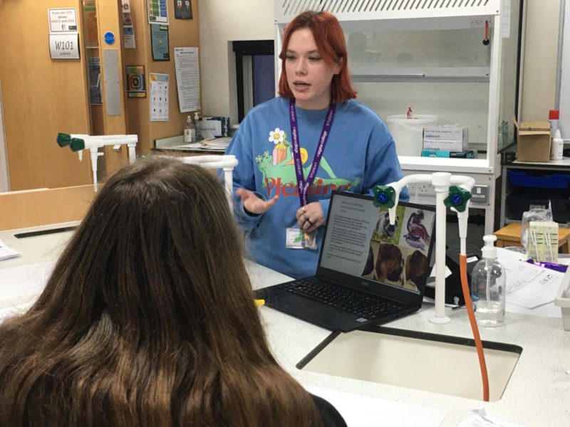 Reigate College student talking to year 10 student during 'Medics, Vets and Dentists' workshop session
