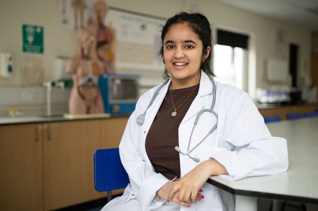 Khushee wearing a lab coat