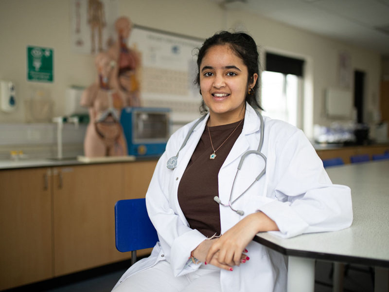 Khushee wearing a lab coat