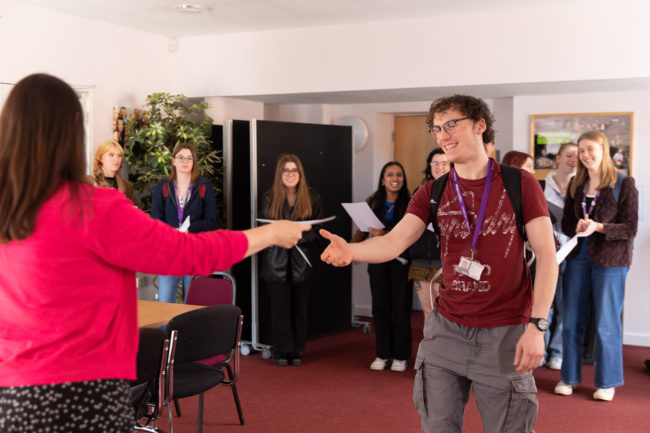 Student receiving Chemistry Olympiad certificate