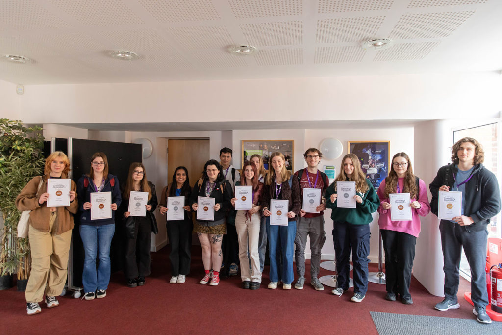 All students that received bronze, silver or gold lined up for a photo with the certificate
