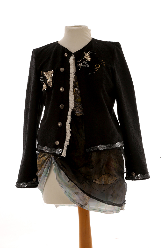 Black jacket over patterned dress on mannequin