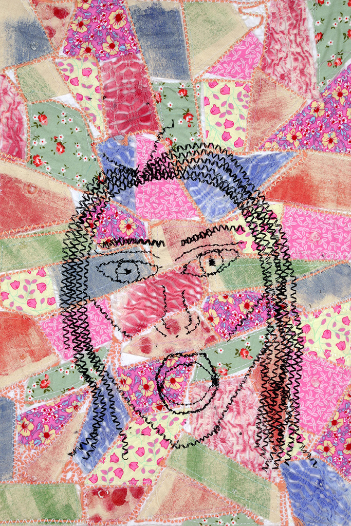 Stitched image of face over patchwork style textile