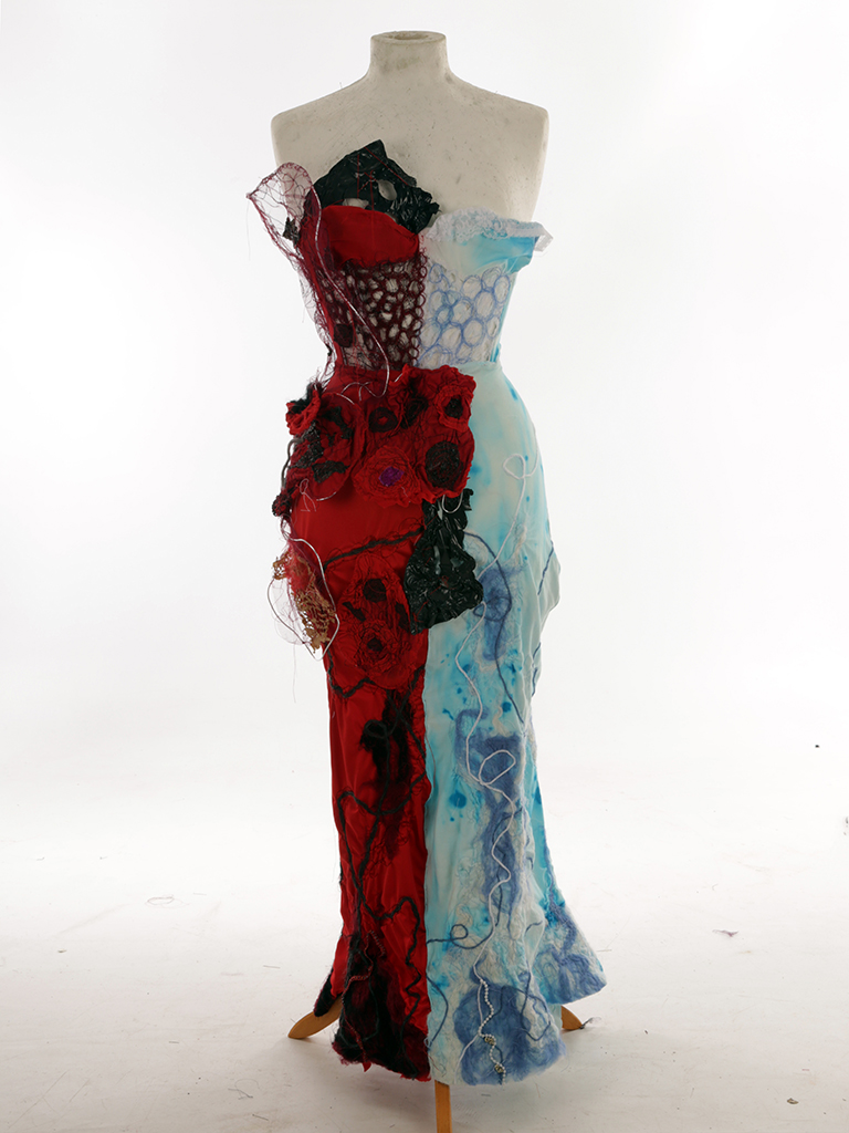 Full length textured strapless dress, half red and black and half blue and white