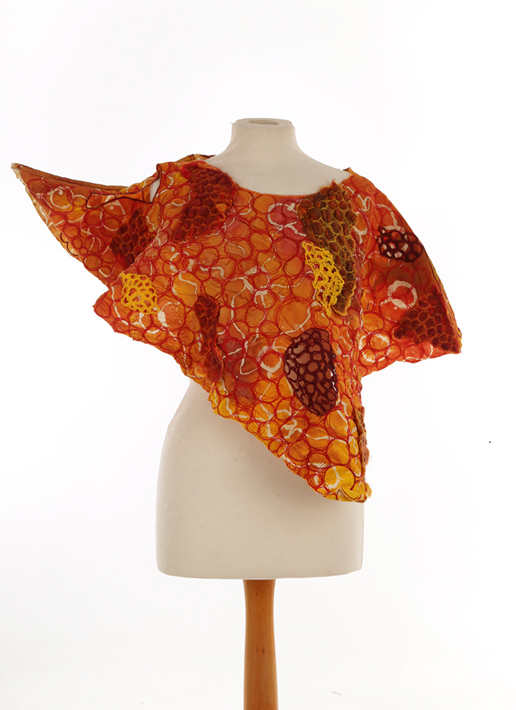 Orange, yellow, red and brown structured top with circle detailing