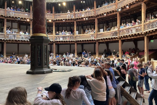 Students looking at stage at Globe theatre