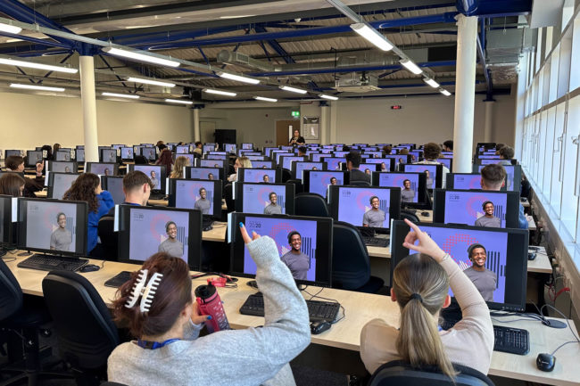 Students raising hands to ask questions