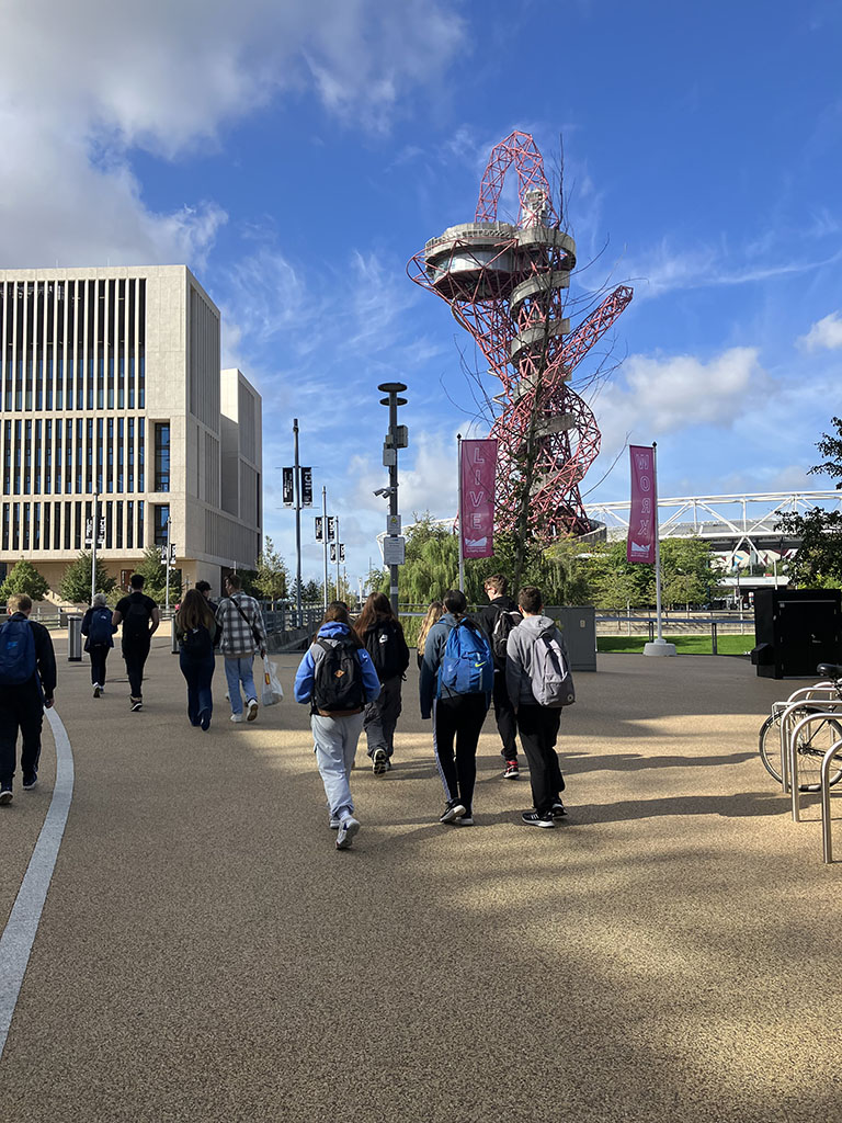 Students walking past the ArcelorMittal Orbit Sculpture in the Olympic Park