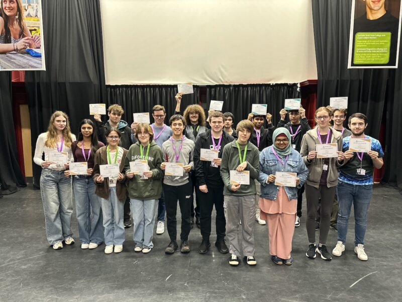 Group photo of students who participated in the UKMT Senior Maths Challenge, all holding their certificates