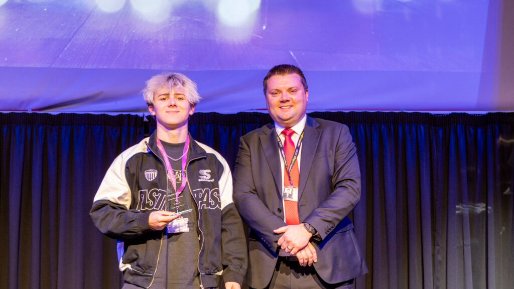 Nick Clarke with a student smiling for a picture