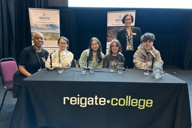 Four students with two members of staff at the guild meeting