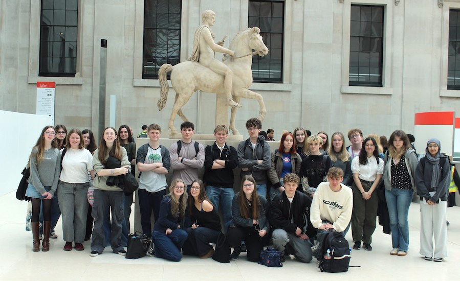 Students in front of a marble statue of a rider on a horse at the British Museum