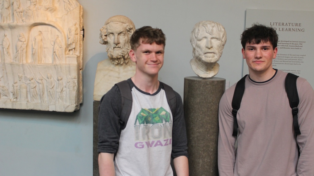 Two students next to carved marble busts at the British Museum