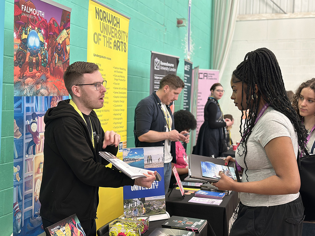 Female student speaking to an exhibitor on the Norwich University of the Arts stand at Get Ahead Day