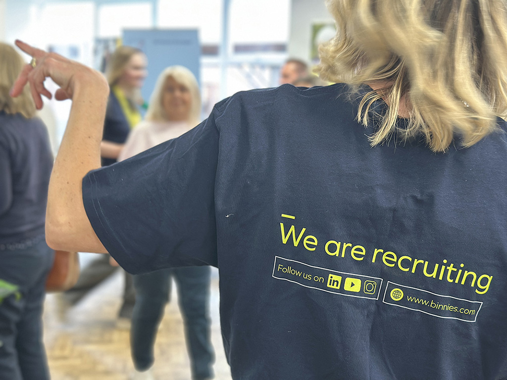 Rear view of an exhibitor wearing a "We are recruiting" slogan T-shirt at the annual Meet the Employer event