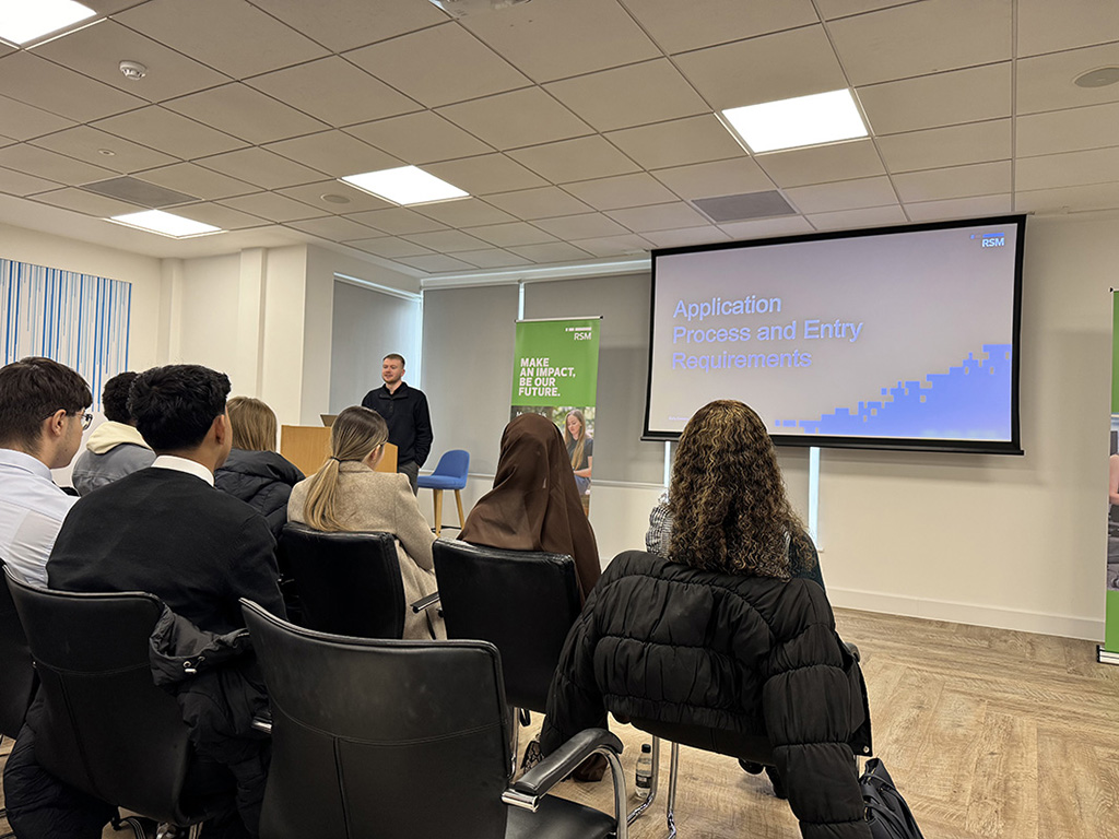 Students listening to a talk during the RSM insight visit