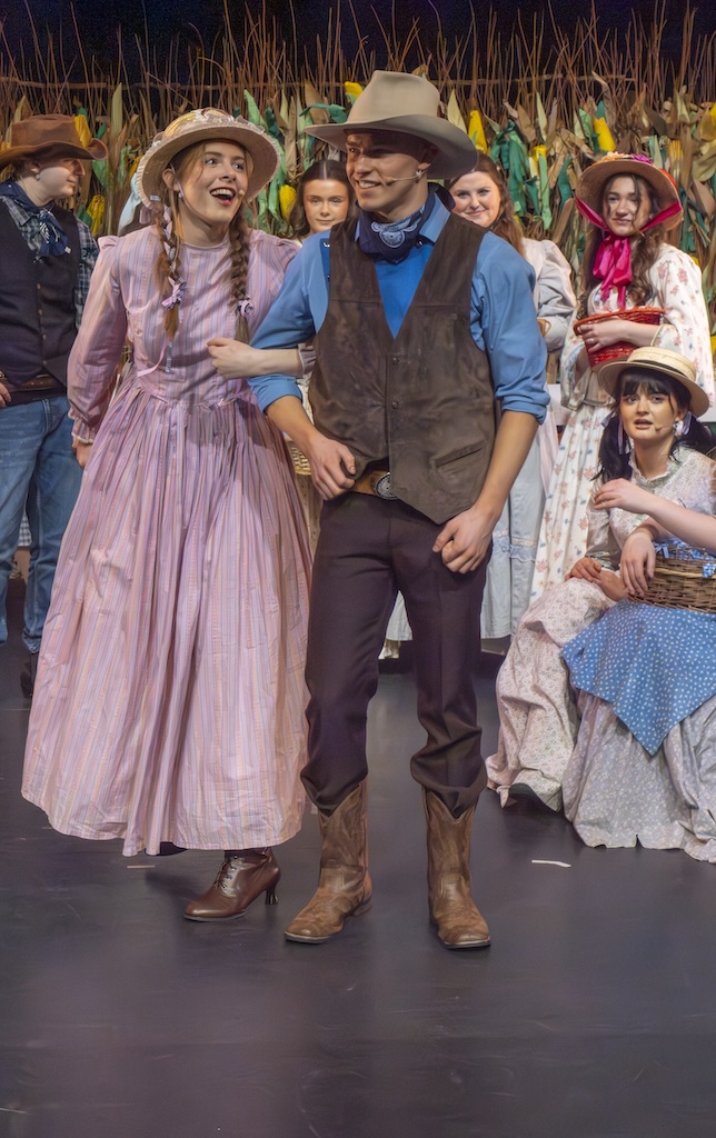 Students performing on stage in the production of Oklahoma