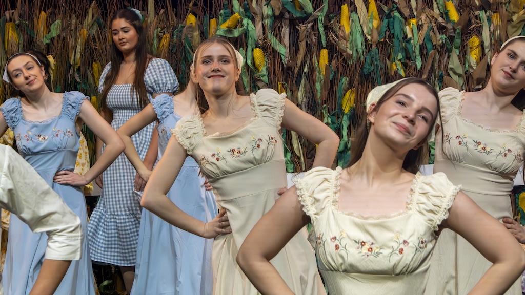Students performing on stage in the production of Oklahoma