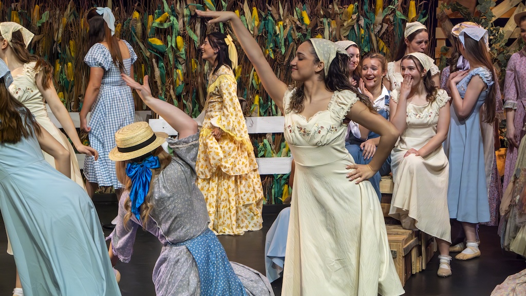 Students performing on stage in the production of Oklahoma