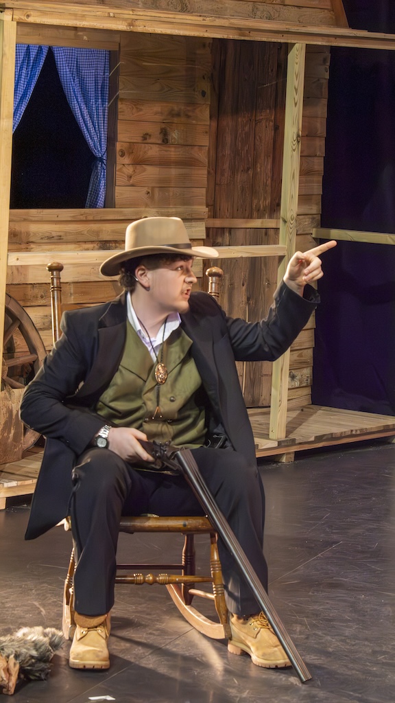 Students performing on stage in the production of Oklahoma - Ado Annie's father