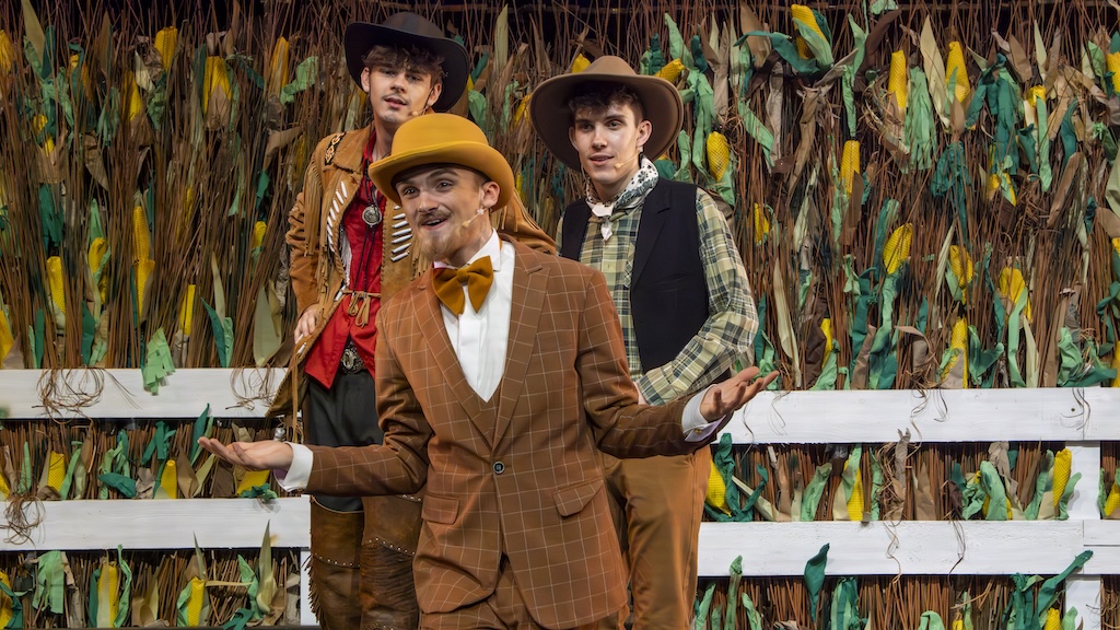 Students performing on stage in the production of Oklahoma
