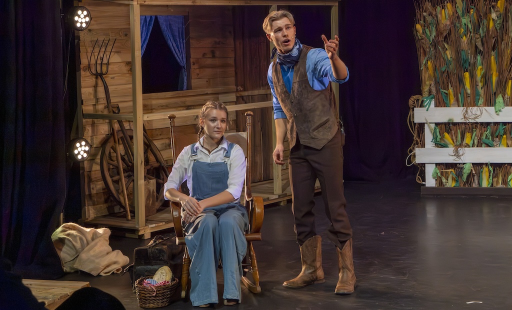 Students performing on stage in the production of Oklahoma - Laurie and Curley
