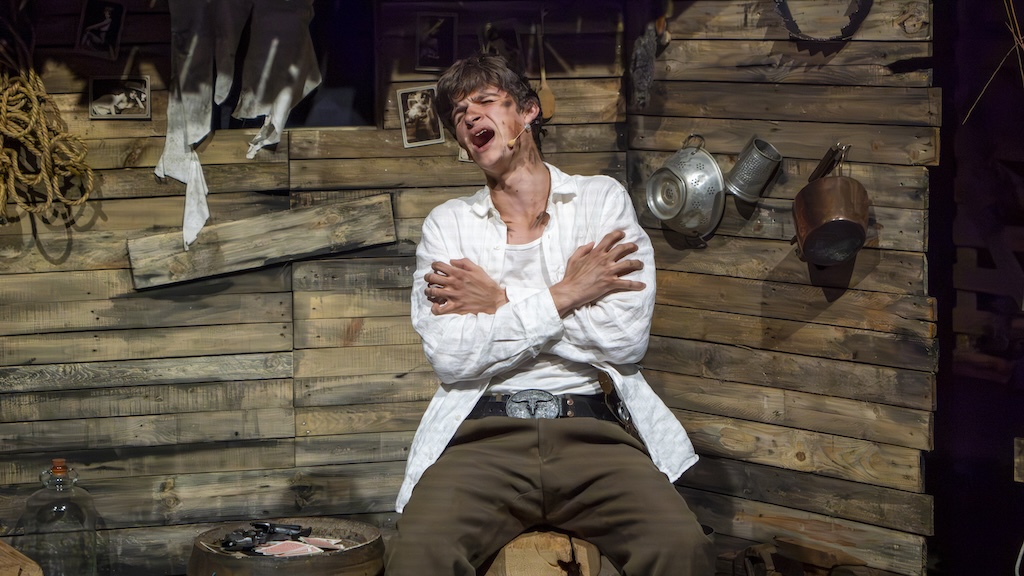 Student performing on stage in the production of Oklahoma - Jud Fry