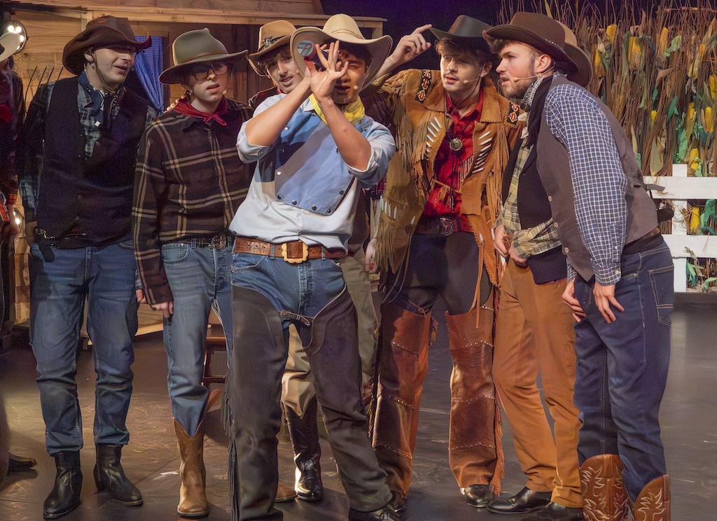 Students performing on stage in the production of Oklahoma