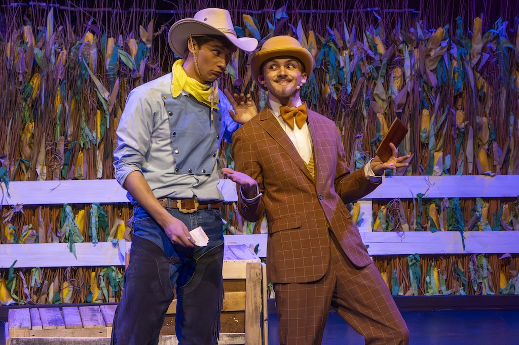 Students performing on stage in the production of Oklahoma