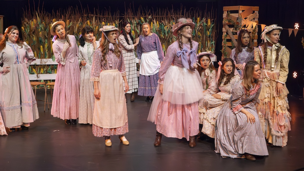 Students performing on stage in the production of Oklahoma