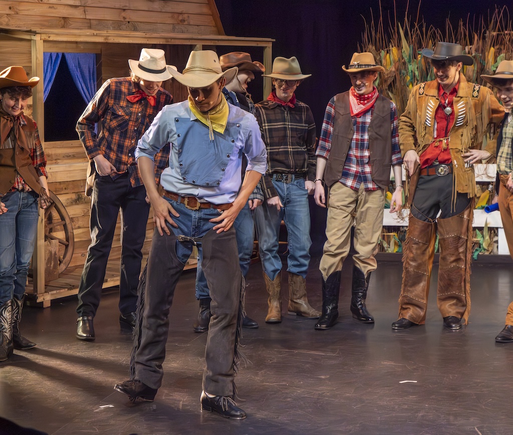 Students performing on stage in the production of Oklahoma - Will Parker's tap dance