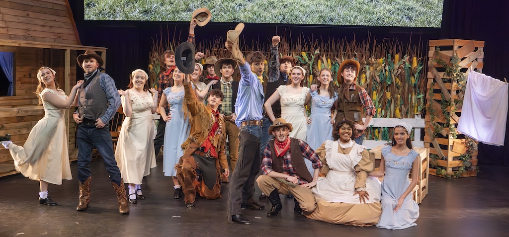 Students performing on stage in the production of Oklahoma