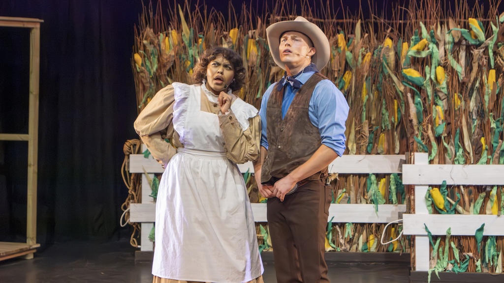 Students performing on stage in the production of Oklahoma - Aunt Eller