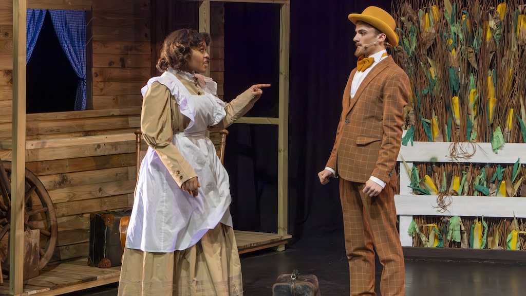 Students performing on stage in the production of Oklahoma - Ali Hakim with Aunt Eller