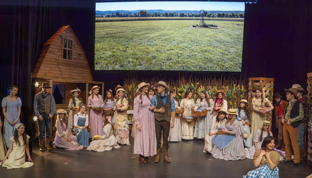 Students performing on stage in the production of Oklahoma