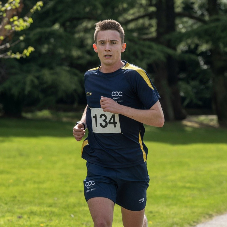 Ewan Sone competing in running kit with race number