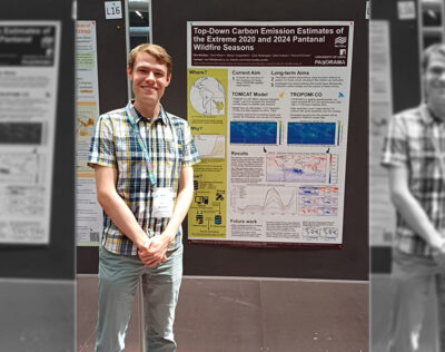 Ben Bradley in front of a carbon emissions poster