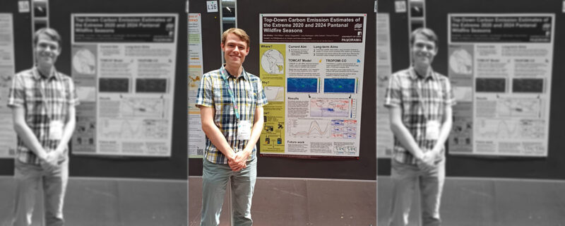 Ben Bradley in front of a carbon emissions poster