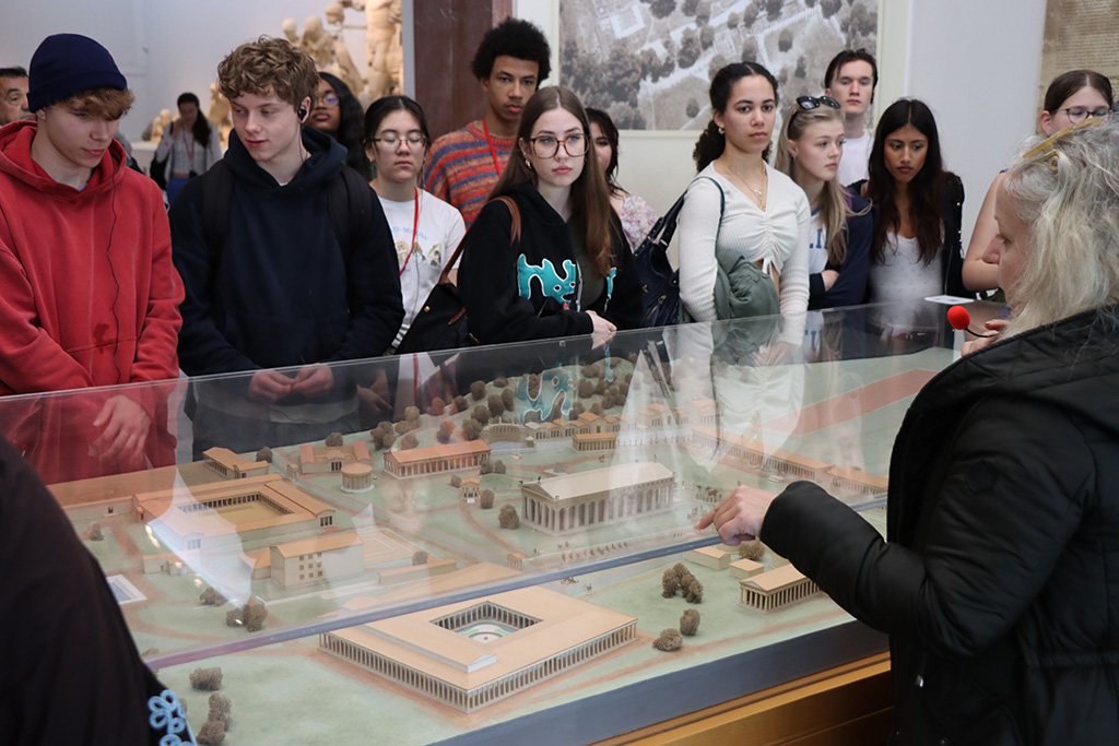 Students in front of an exhibition case learning about Olympia