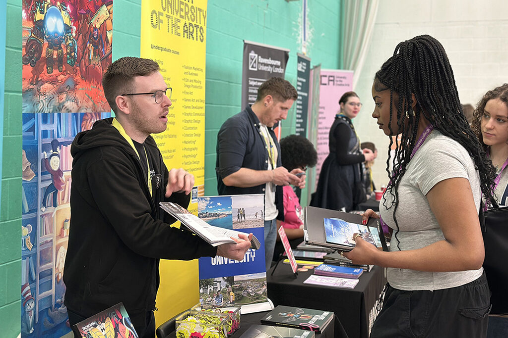 Female student speaking to an exhibitor on the Norwich University of the Arts stand at Get Ahead Day