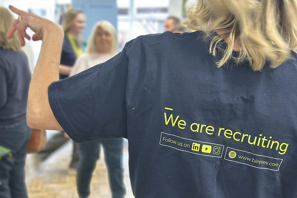 Rear view of an exhibitor wearing a "We are recruiting" slogan T-shirt at the annual Meet the Employer event