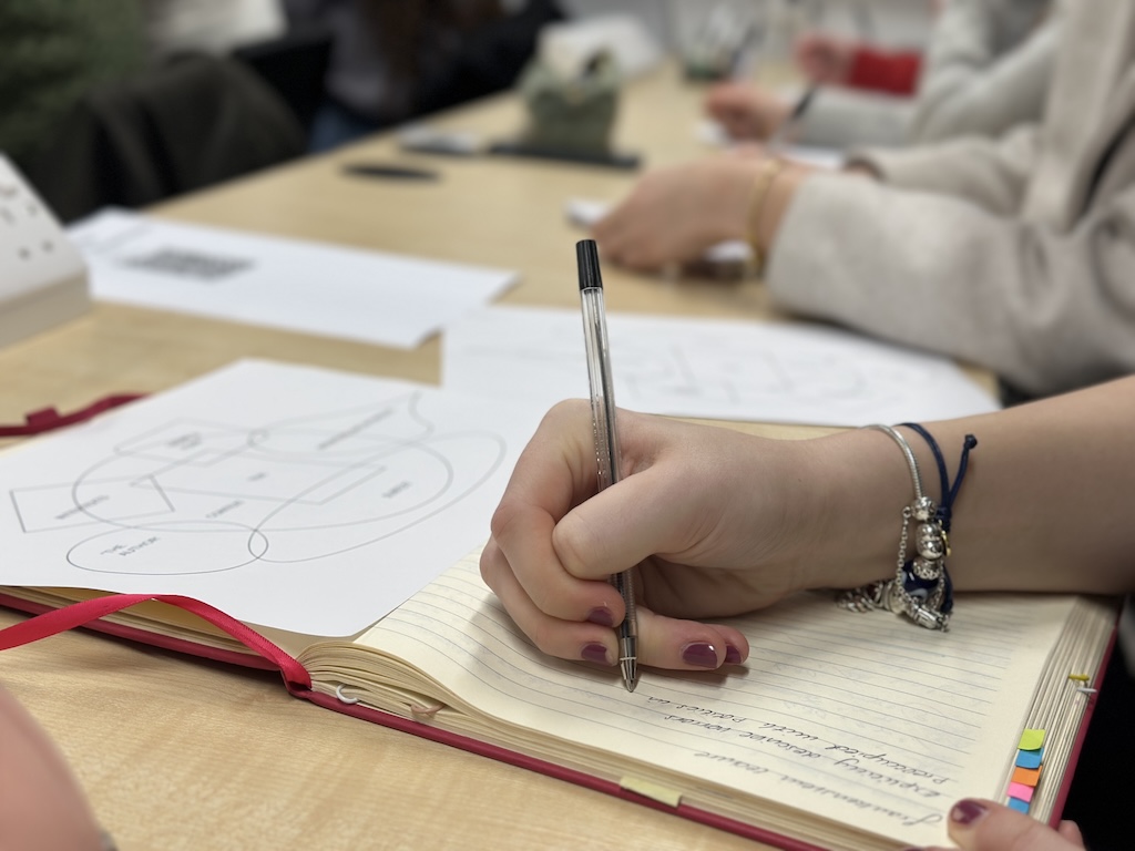 Students taking handwritten notes
